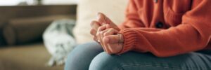 closeup of woman's hands, picking at the nails with anxiety